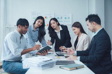 Collaborative Business Meeting: A diverse team of professionals engages in a productive meeting, reviewing documents and collaborating on a project.  The image exudes efficiency and teamwork.