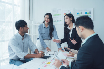 Fototapeta premium Collaborative Business Meeting: A diverse team of professionals engages in a lively discussion around a table, showcasing their collaborative spirit and dedication to achieving shared goals. 