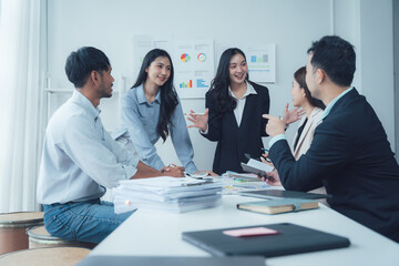 Business Meeting Brainstorm:  A diverse team of business professionals engaged in a lively brainstorming session, their ideas flowing freely as they work together to achieve a common goal.  