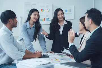 Teamwork Makes the Dream Work: A diverse team of professionals collaborates in a modern office setting, engaged in a lively brainstorming session.