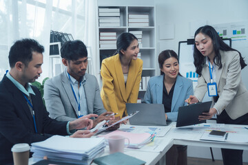 Diverse Team Collaboration: A group of  business professionals discuss ideas and strategize around a table, showcasing a collaborative and dynamic workplace environment.