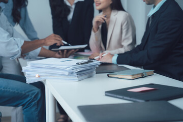Business Professionals Collaborate: A diverse group of business professionals engage in a collaborative discussion.