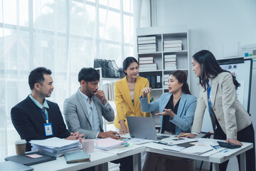 Business Meeting: A diverse team of professionals engaged in a productive meeting, collaborating...