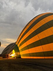 Obraz premium Colorful hot air balloons being inflated at dawn 