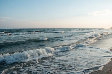 ocean waves gently lapping against the shore, tide, coastal landscape, water