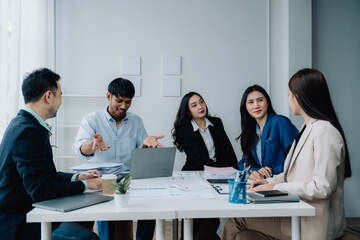 Collaborative Brainstorming: Diverse Business Professionals Engage in a Lively Discussion Around a Conference Table, Sharing Ideas and Strategies for Success.  