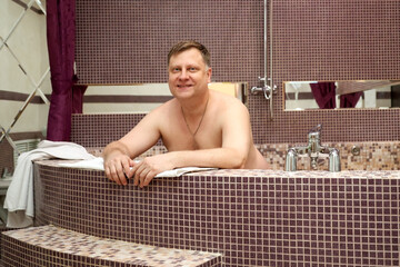 A rich man bathes in his own jacuzzi in a large private house