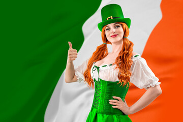 Young red-haired woman in a green Leprechaun elf costume during a St. Patrick's Day party. Happy...