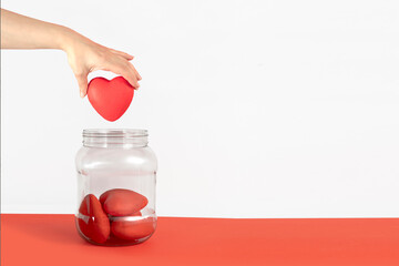 Hand collecting hearts in a transparent jar. love relationship collector, rejected love, emotions...