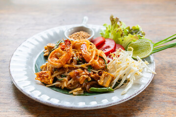 Fried noodle Thai style with prawns or Pad Thai, famous traditional Thai food street food in Thailand.