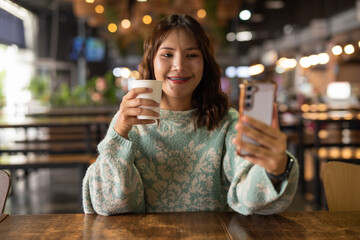 Portrait of Beautiful And Young Cute Asian Woman Having Coffee Break in Cafe Restaurant