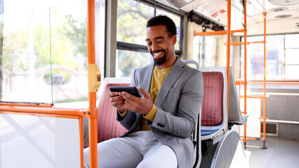 Passenger checking messages on his phone while traveling on the bus