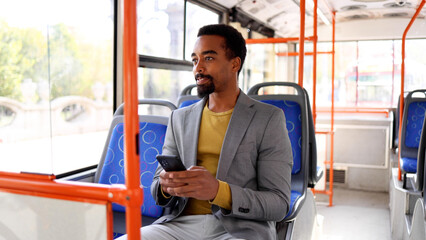 Passenger checking messages on his phone while traveling on the bus