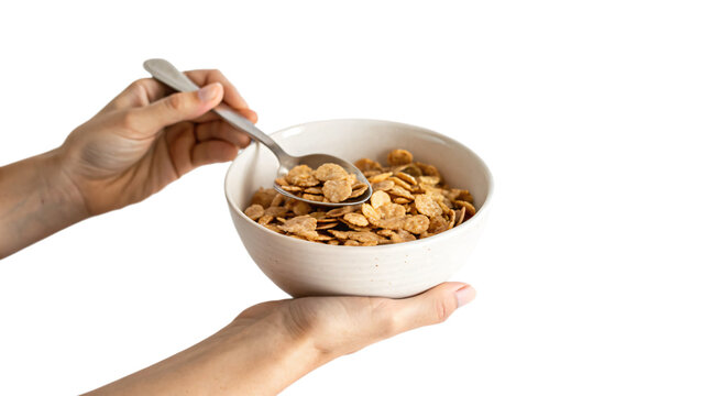 a hand holding a bowl with cereal