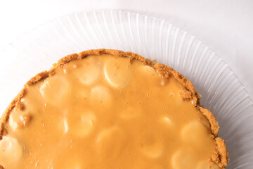 Banoffee banana pie with caramel sauce on the white background. Traditional english cake. Ready to eat. Cooking concept