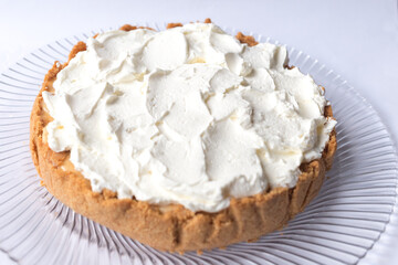 Banoffee banana pie with caramel sauce and cheese cream on the white background. Traditional english cake. Ready to eat. Cooking concept