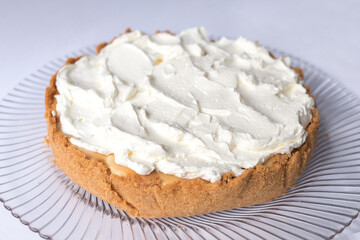 Banoffee banana pie with caramel sauce and cheese cream on the white background. Traditional english cake. Ready to eat. Cooking concept