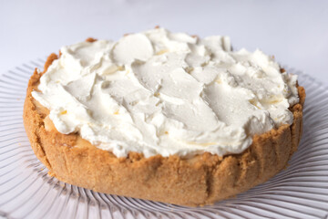 Banoffee banana pie with caramel sauce and cheese cream on the white background. Traditional english cake. Ready to eat. Cooking concept