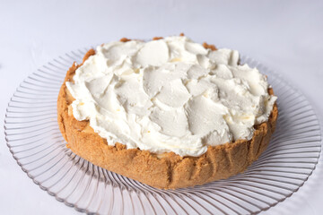 Banoffee banana pie with caramel sauce and cheese cream on the white background. Traditional english cake. Ready to eat. Cooking concept