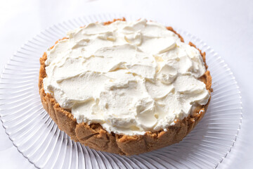 Banoffee banana pie with caramel sauce and cheese cream on the white background. Traditional english cake. Ready to eat. Cooking concept