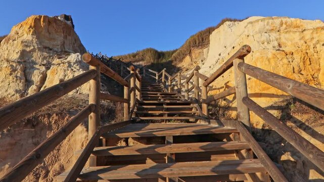 Walkway with wooden steps on Cuesta Maneli beach, located in a very unique environment, the fossil dune system of El Asperillo, located within the Do&ntilde;ana Natural Park , Huelva, Spain.