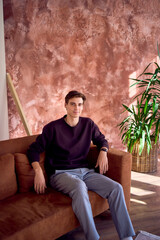 portrait of an attractive young 20 year old man with dark hair and blue eyes, studio photo shoot