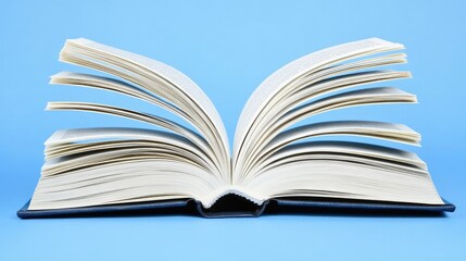 Fototapeta premium Open Book on Blue Background Displaying Pages