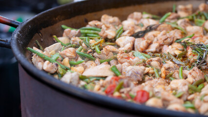 Delicious street food: tender chicken, fragrant curry, and fresh green beans and fluffy rice cooked on the spot. A perfect balance of flavors, delicious meal of farmer's market.