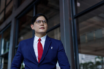 Male portrait standing confident wear suit professional businessperson lifestyle. Manager businessman suit and tie success stand near at  modern office.