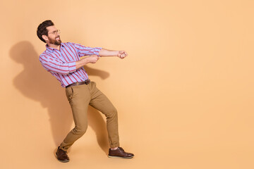 Full size photo of nice young male pull heavy empty space wear trendy striped formalwear isolated...