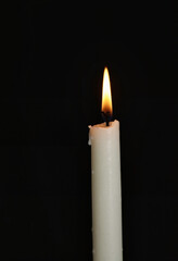 A solitary candle burns brightly, symbolizing hope and remembrance on World Cancer Day