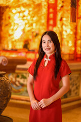 Elegant Woman in Red Dress with Golden Background