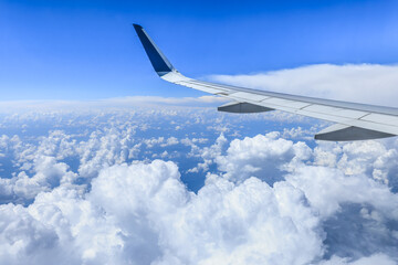 Airplane wing and sky cloudscape in stratosphere