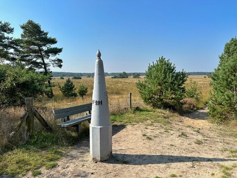 Border post Netherlands-Belgium with a bench in nature reserve between Luycksgestel and Lommel.