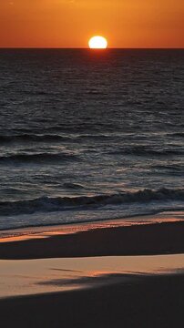 Golden hour on the beach. Cuesta Maneli, Arenosillo, Do&ntilde;ana, Matalasca&ntilde;as, Mazagon, Huelva, Spain, Andalusia, Holidays, Relaxation, orange color, golden color. Vertical