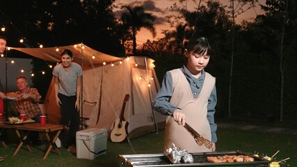 Family gather celebrate holiday, Adorable child grill food for family member. Outdoor camping...