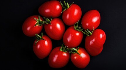 Bunch of small ripe red Roma or plum cocktail tomatoes viewed from above