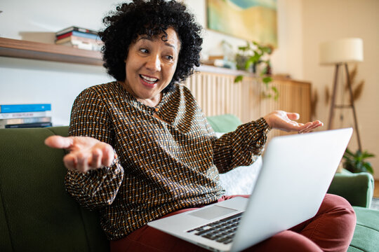 Frustrated woman on video call working from home on laptop