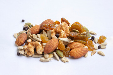 Heap of different tasty nuts isolated .Assorted Nuts. Pistachios, Almonds, Hazelnuts, walnuts, Cashews falling set, isolated. Assorted nuts mix floating on white background. Fresh dry fruits isolated.