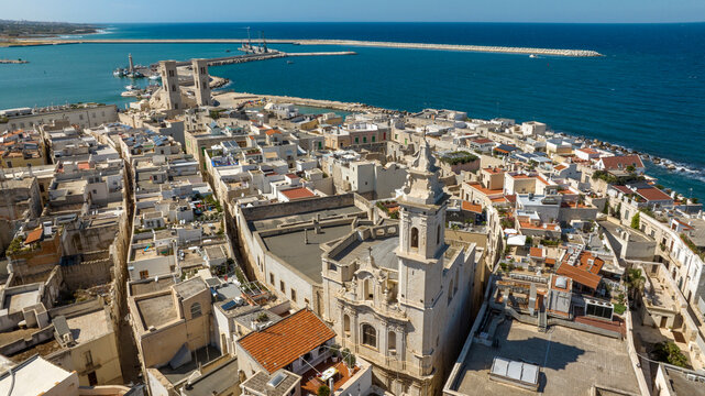 Aerial view of the church of San Pietro Apostolo located in the old town of Molfetta, in the province of Bari, Puglia, Italy. In background is the church of San Corrado and the port of the town.