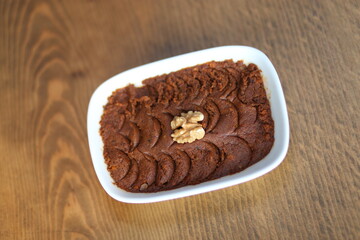 A bowl of traditional Turkish ezme, a flavorful dip made with roasted red peppers, walnuts, and...