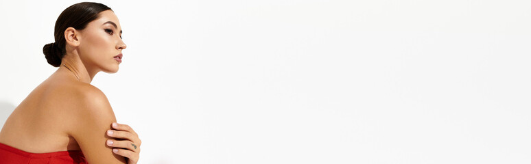 A stunning young woman showcases her elegance and confidence with a captivating pose.