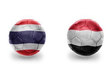football balls with national flags of yemen and thailand , soccer teams. on the white background.