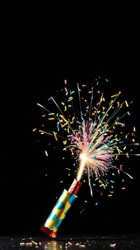 Party Popper Explosion in Slow Motion with Dark Background and Text Space