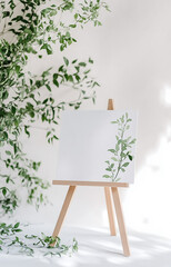 A white card with a leaf design sits on a wooden stand. 