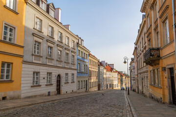 Mostowa Street in New Town, Warsaw, Poland. Narrow streets in the city center. Beautiful building facades, paved road