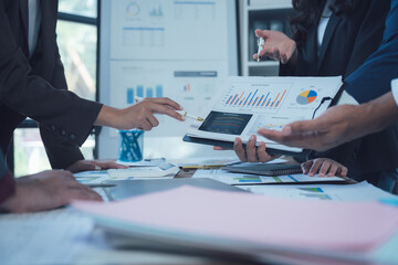 Strategic Business Meeting: Hands-on analysis of financial charts and graphs during a collaborative business meeting.  Focus on teamwork and data-driven decision-making.