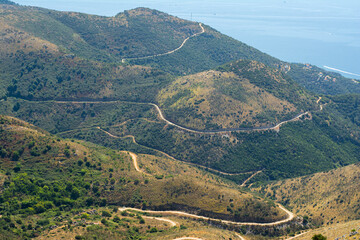 Naklejka premium Winding road on Corfu, Greece. Serpentine with sea view.