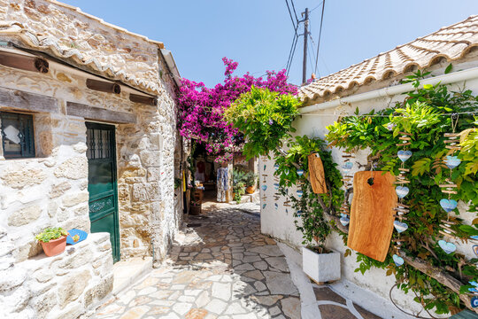Alley decorated with flowers in the picturesque village of Afionas on the island of Corfu in Greece