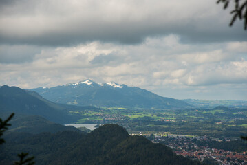 clouds over the snow peaked mountains